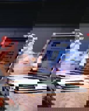 photo of a person in a meeting explaining things while gesticulating.