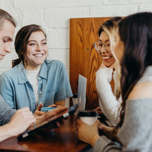 Four people smiling in a meeting
