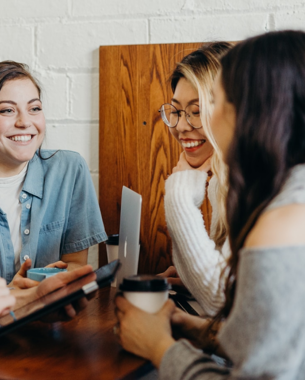 Four people smiling in a meeting