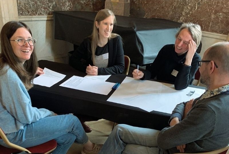 Knowledge Hub members laughing as they discuss the future of OS.