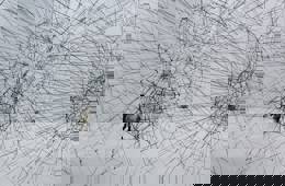 Photo of an artwork consisting of three translucent black spheres made from ropes. They are connected to each other like a kind of network. 