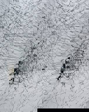 Photo of an artwork consisting of three translucent black spheres made from ropes. They are connected to each other like a kind of network. 